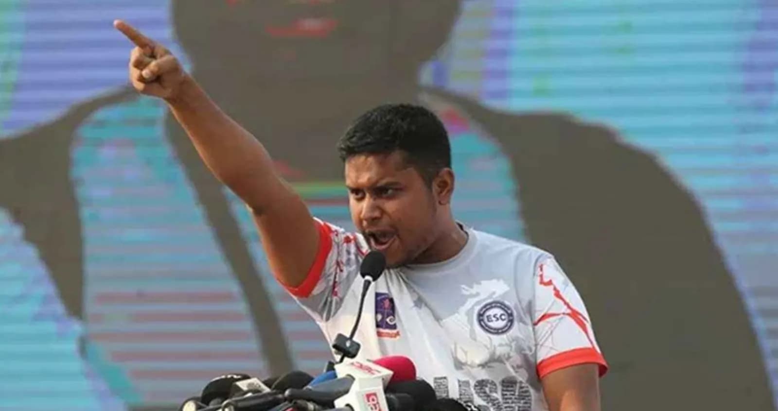 Hasnat Abdullah speaking passionately at a microphone during the July Uprising